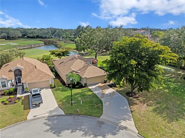 an aerial view of a house with a garden and lake view