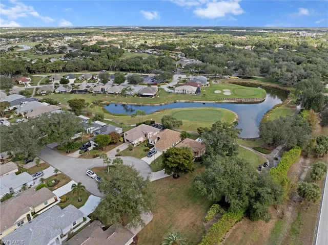 an aerial view of a residential houses with outdoor space and street view