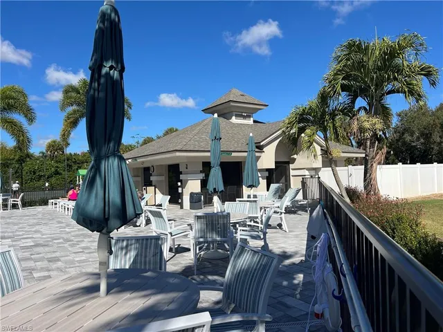 a view of a patio with table and chairs and potted plants