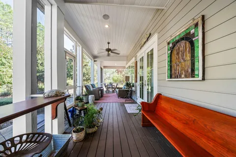 a view of balcony with chairs potted plant with a large window