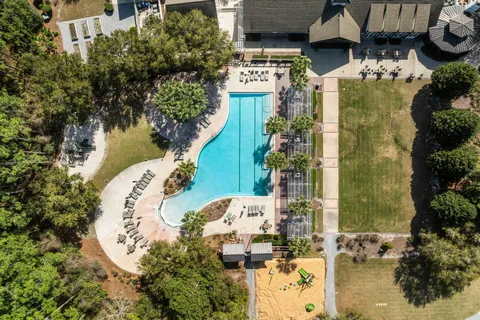 an aerial view of a residential houses with outdoor space