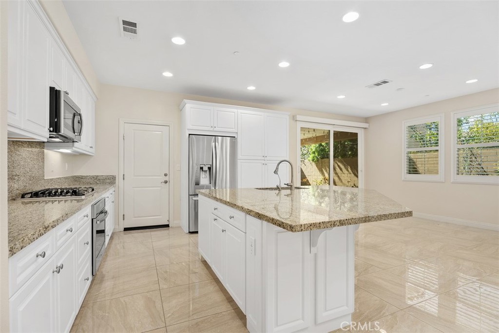 259 Wicker Irvine, CA 92618 - Photo 12 of 30 a kitchen with stainless steel appliances granite countertop a sink stove and refrigerator