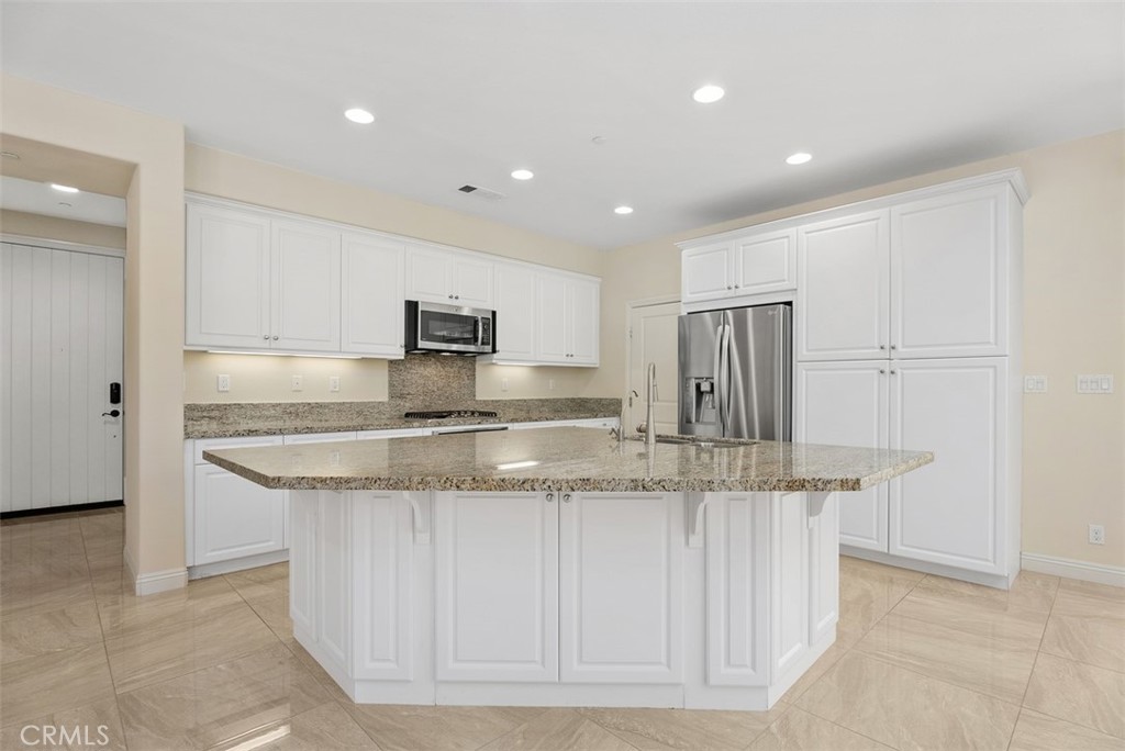 259 Wicker Irvine, CA 92618 - Photo 13 of 30 a kitchen with stainless steel appliances granite countertop a sink and a refrigerator
