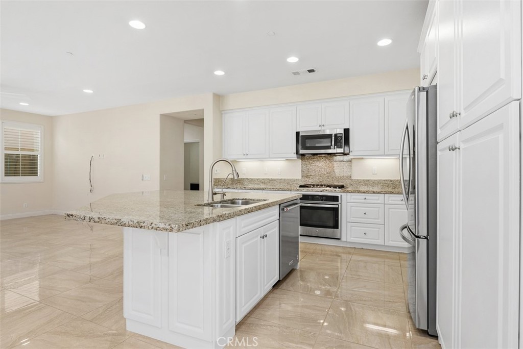 259 Wicker Irvine, CA 92618 - Photo 14 of 30 a kitchen with stainless steel appliances granite countertop a stove and a refrigerator