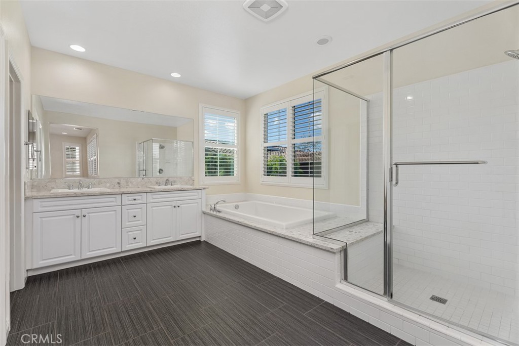 259 Wicker Irvine, CA 92618 - Photo 22 of 30 a large white bathroom with a granite countertop sink mirror and bathtub