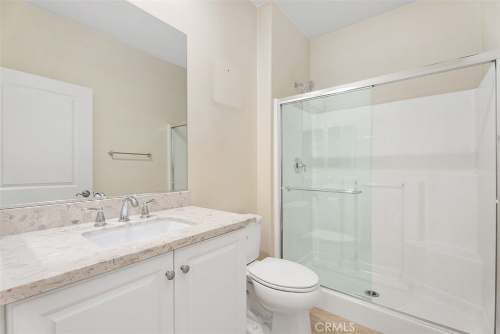 259 Wicker Irvine, CA 92618 - Photo 8 of 30 a bathroom with a granite countertop sink toilet and shower
