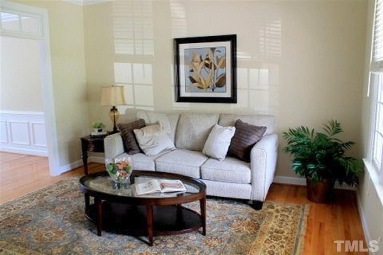 7712 Wilderness Road Raleigh, NC 27613 - Photo 11 of 25 a living room with furniture and a potted plant