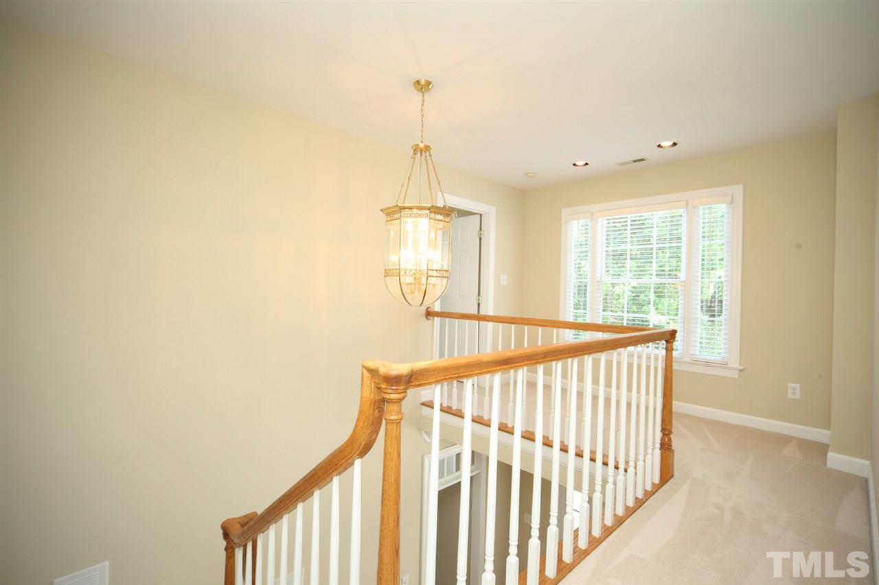7712 Wilderness Road Raleigh, NC 27613 - Photo 13 of 25 a view of a hallway with window