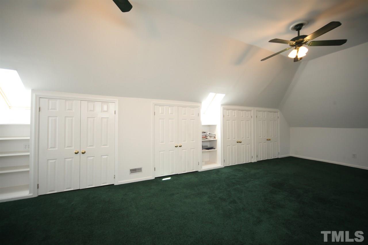 7712 Wilderness Road Raleigh, NC 27613 - Photo 21 of 25 an empty room with a fan and a window