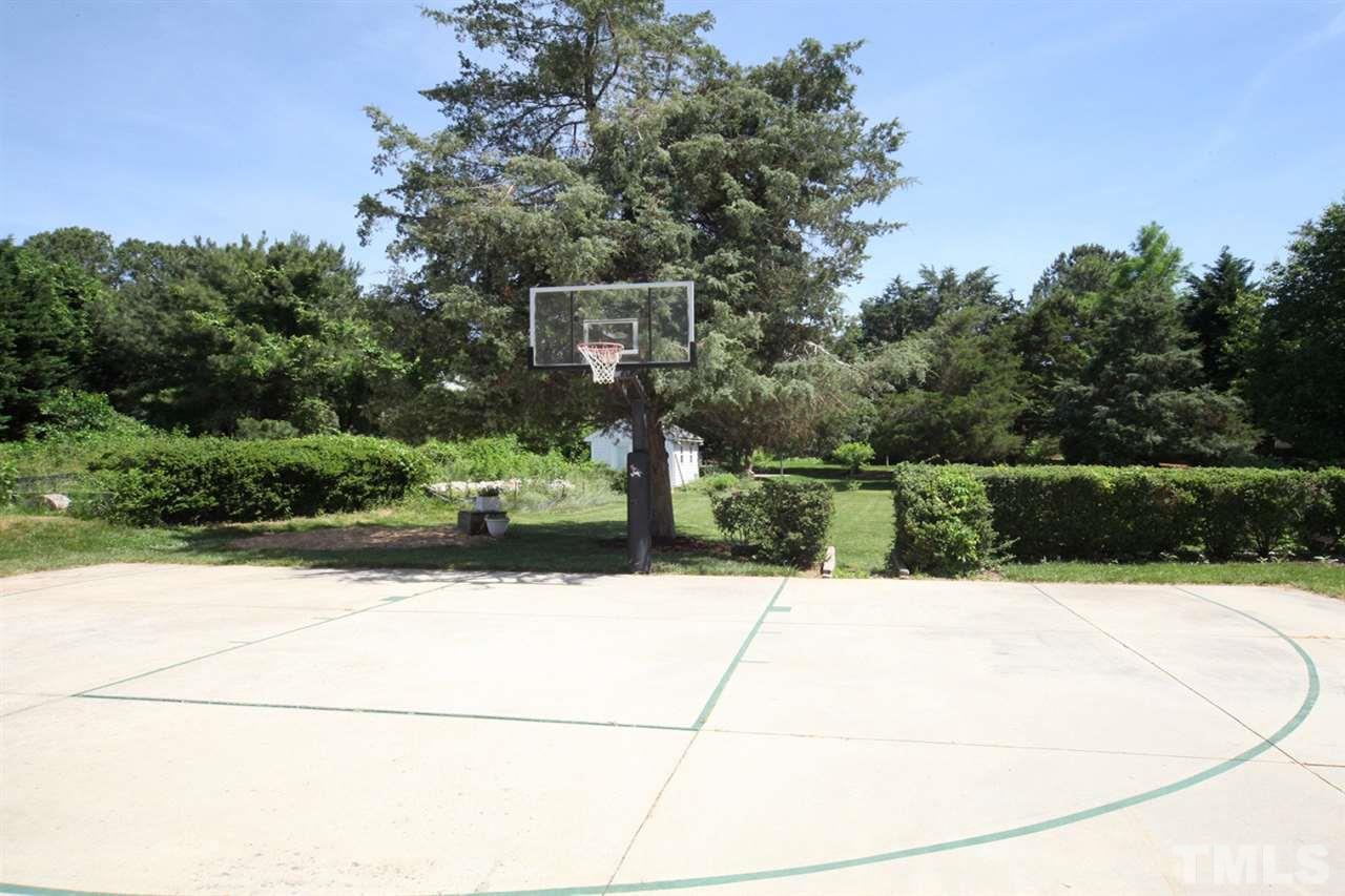 7712 Wilderness Road Raleigh, NC 27613 - Photo 22 of 25 a swimming pool with buildings in the background