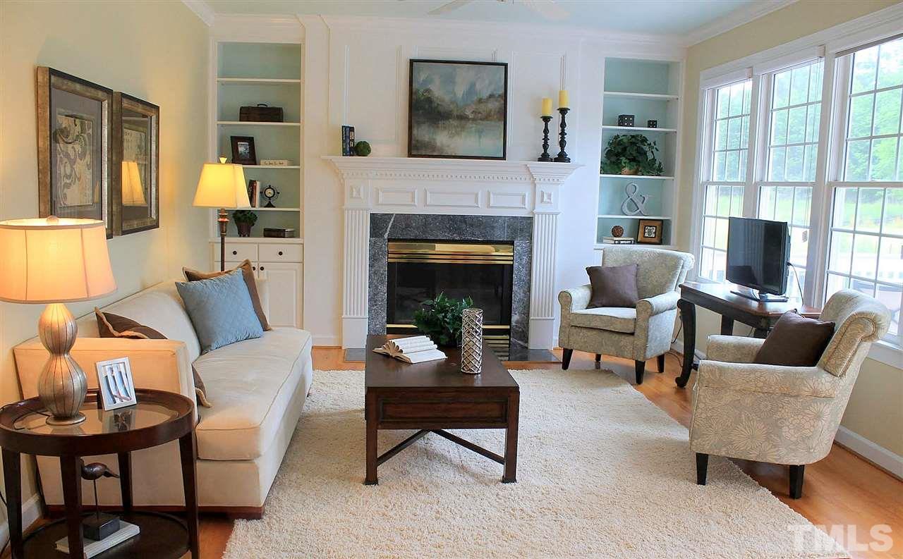 7712 Wilderness Road Raleigh, NC 27613 - Photo 4 of 25 a living room with furniture and a fireplace