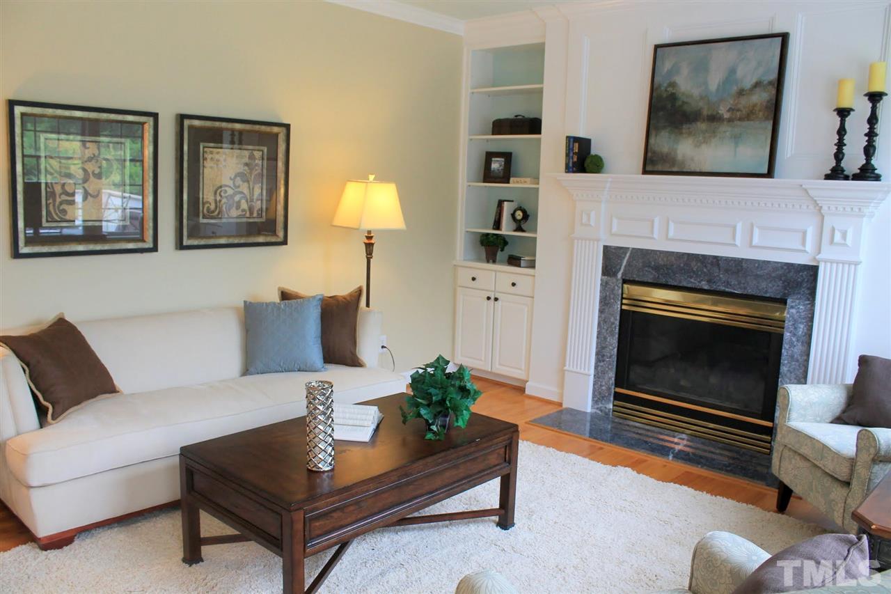 7712 Wilderness Road Raleigh, NC 27613 - Photo 5 of 25 a living room with furniture and a fireplace