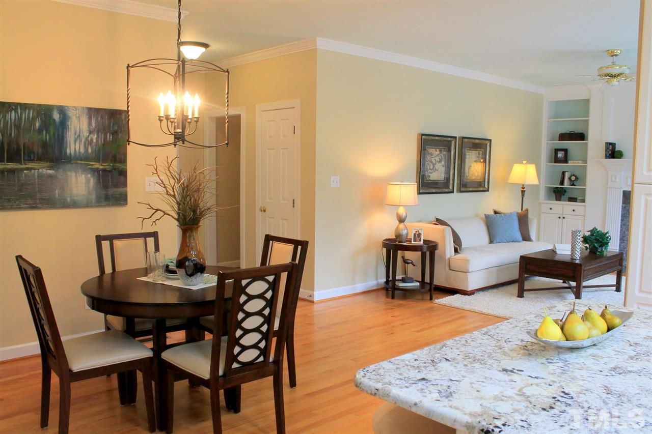 7712 Wilderness Road Raleigh, NC 27613 - Photo 9 of 25 a living room with furniture and wooden floor