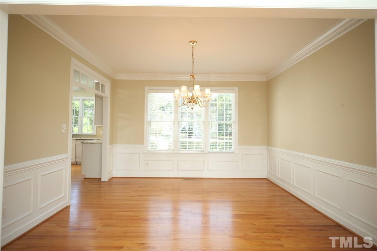 7712 Wilderness Road Raleigh, NC 27613 - Photo 10 of 25 a view of an empty room with wooden floor and a window