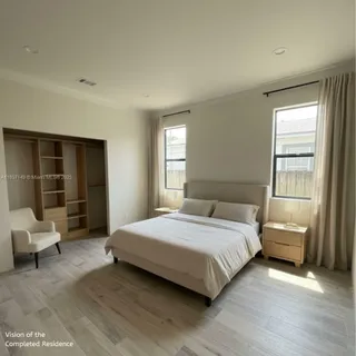 a view of an empty room with wooden floor and windows
