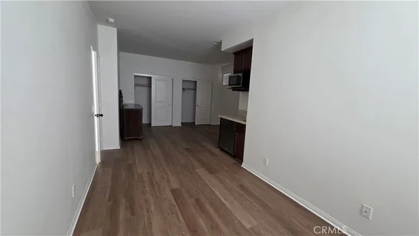 a view of hallway with wooden floor