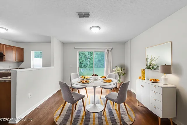 a dining room with furniture and window