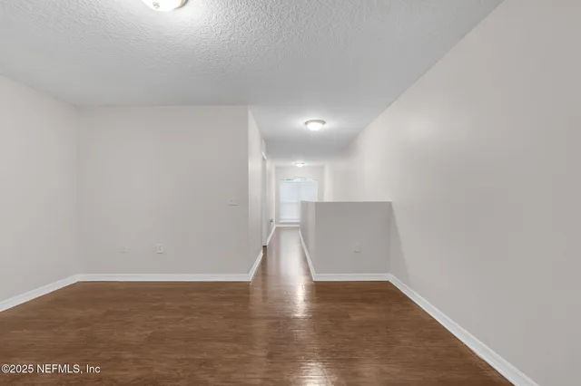 a view of room with wooden floor