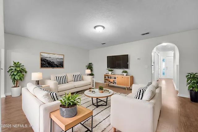 a living room with furniture and a flat screen tv