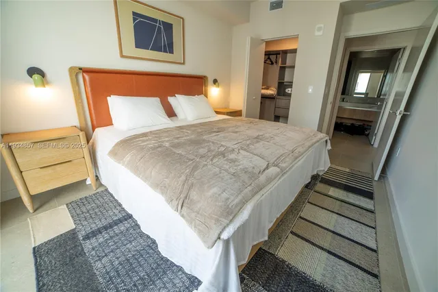 a bed sitting in a bedroom and balcony