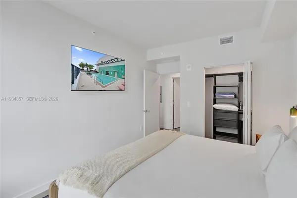 a bed room with two bed and a flat screen tv