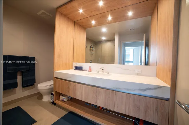 a bathroom with a double vanity sink and a toilet