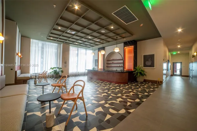 a living room with furniture a rug and a chandelier