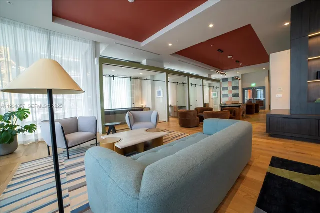 a living room with furniture and a chandelier