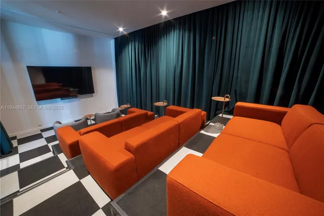 a blue bed sitting in a bedroom next to a large window