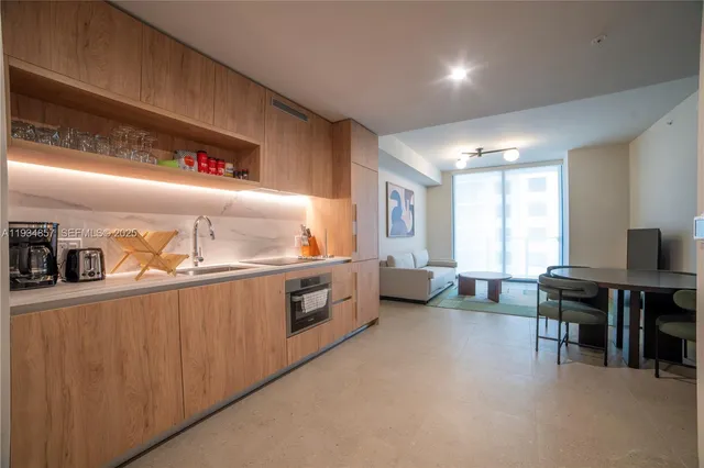 a kitchen with stove a sink and a refrigerator