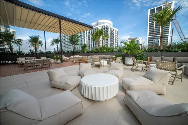 a view of a patio with couches and a fire pit