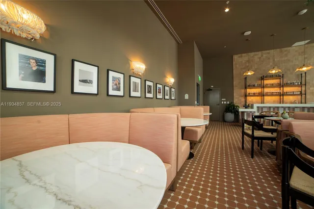 a dining room with furniture and a potted plant