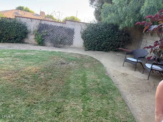 a living room with furniture and large windows