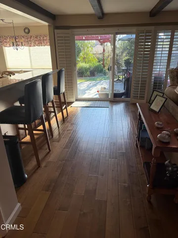 a view of a dining room with furniture and chandelier