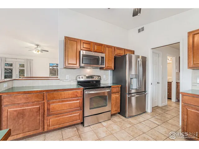 a kitchen with stainless steel appliances granite countertop a sink and cabinets