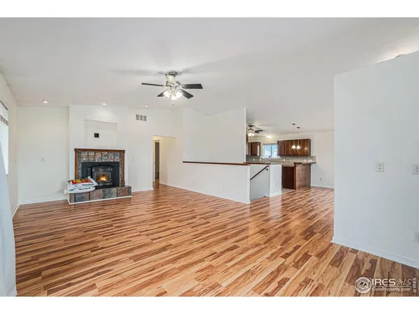 a view empty room with wooden floor and ceiling fan