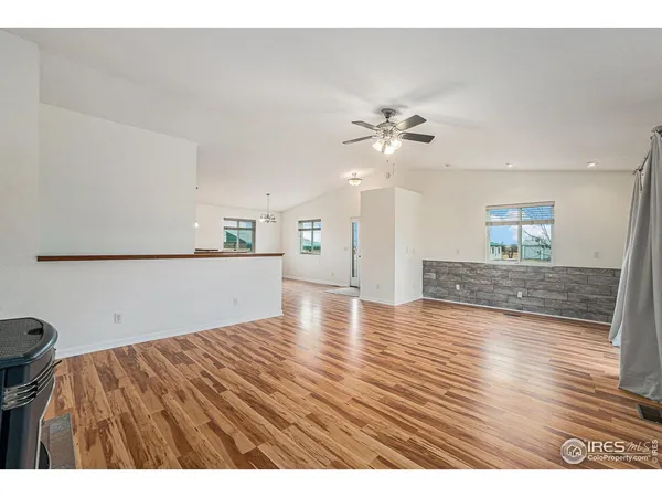 a view interior of kitchen and hall with wooden floor