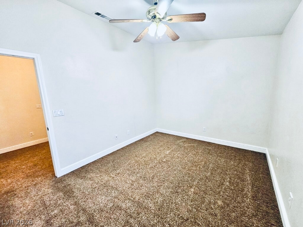 5953 Crumbling Ridge Street Henderson, NV 89011 - Photo 27 of 42 An inviting room awaits personalization, complete with soft carpet and a ceiling fan.