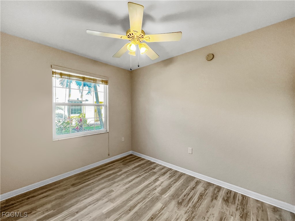 16285 Coco Hammock Way, Unit 101 Fort Myers, FL 33908 - Photo 14 of 50 an empty room with a window