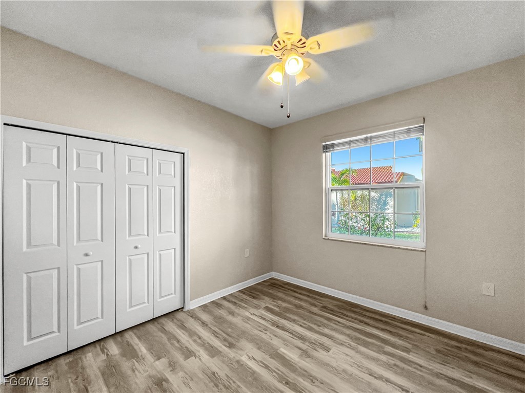 16285 Coco Hammock Way, Unit 101 Fort Myers, FL 33908 - Photo 15 of 50 an empty room with windows