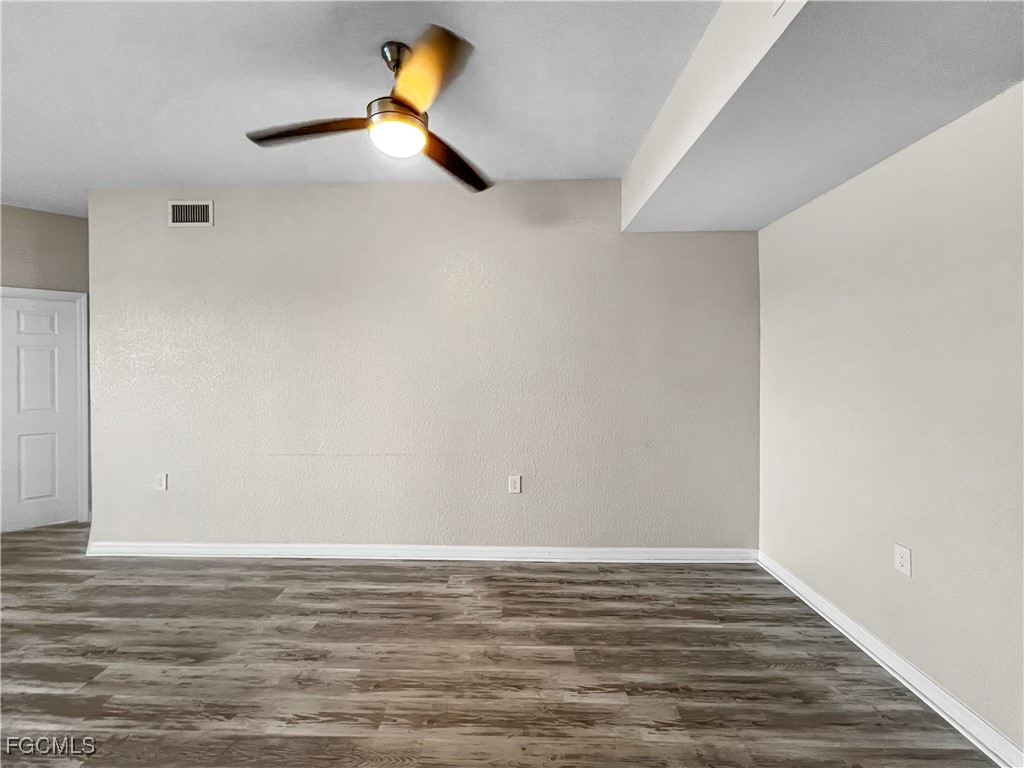 16285 Coco Hammock Way, Unit 101 Fort Myers, FL 33908 - Photo 20 of 50 a view of a room with wooden floor