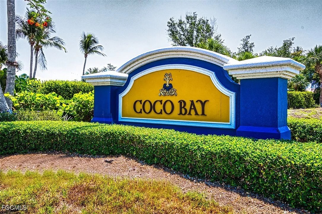 16285 Coco Hammock Way, Unit 101 Fort Myers, FL 33908 - Photo 41 of 50 a view of sign board with flower around