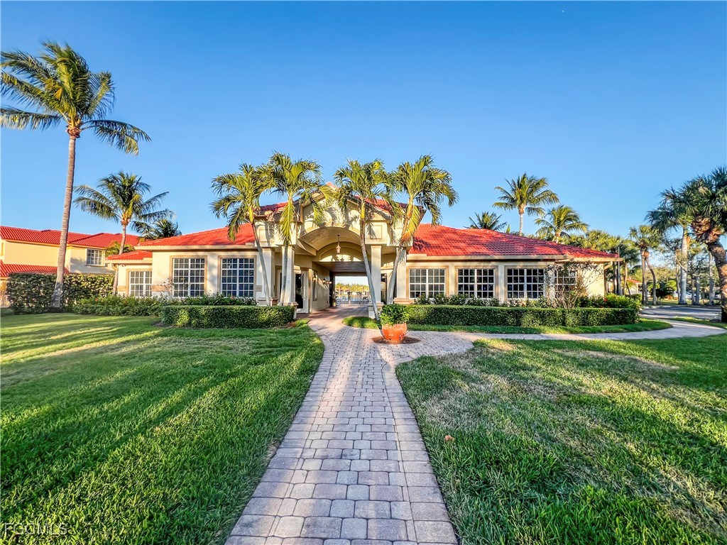 16285 Coco Hammock Way, Unit 101 Fort Myers, FL 33908 - Photo 42 of 50 a front view of a house with a yard