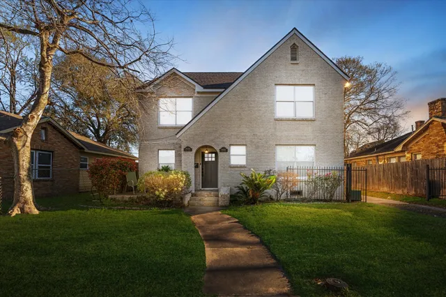 a front view of a house with a yard and outdoor seating