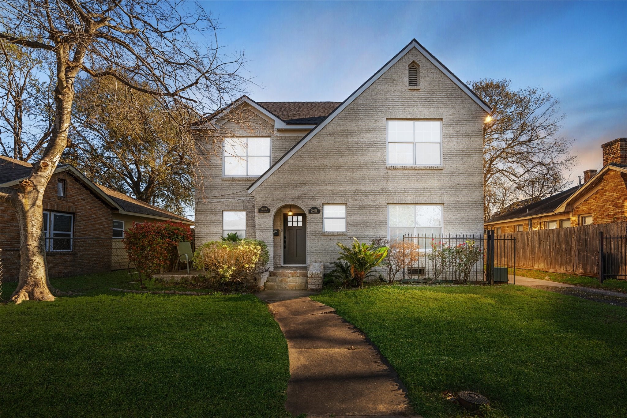 a front view of a house with a yard and outdoor seating