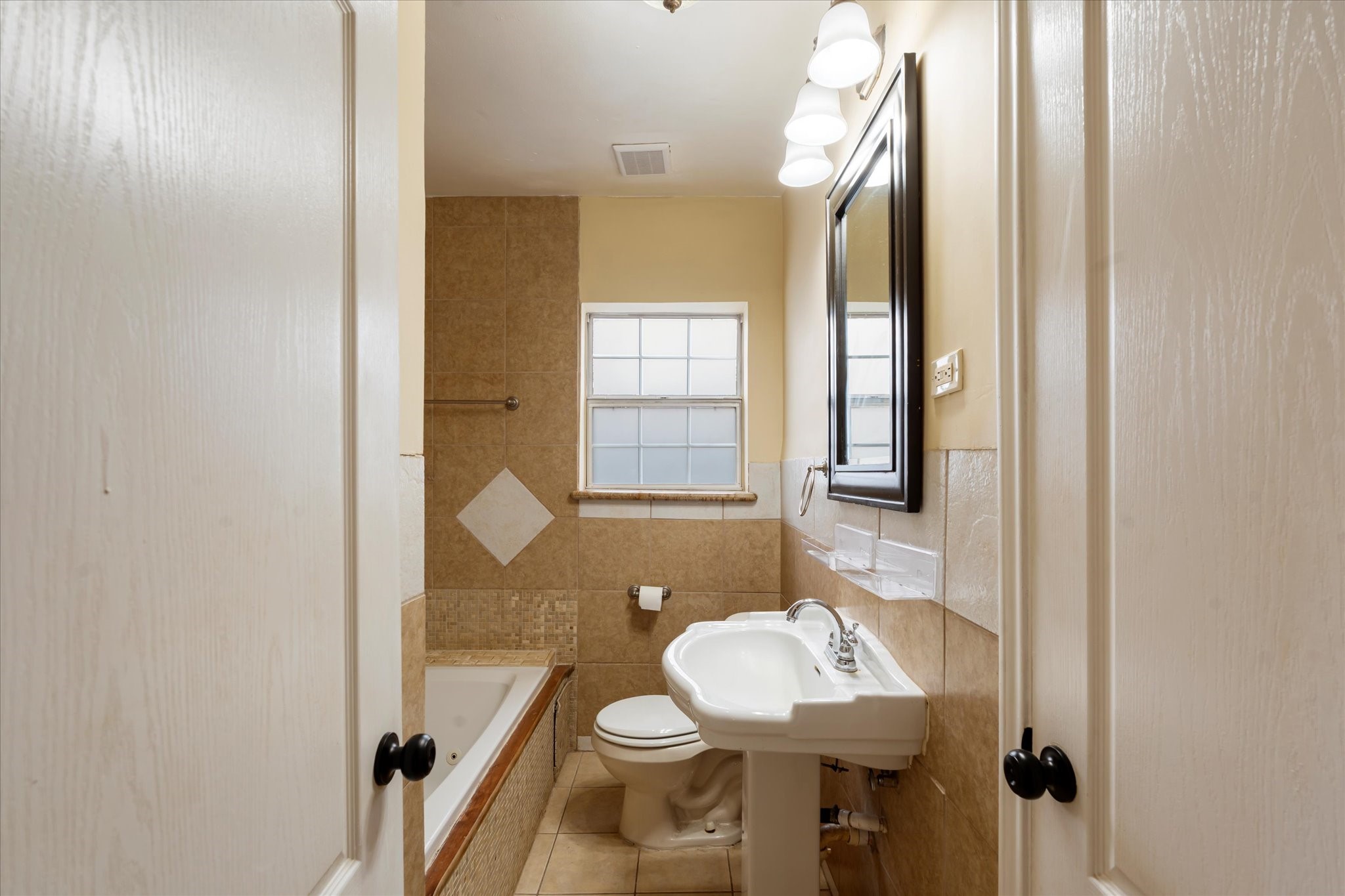 3005 Arbor Street, Unit B Houston, TX 77004 - Photo 11 of 22 a bathroom with a sink and a mirror