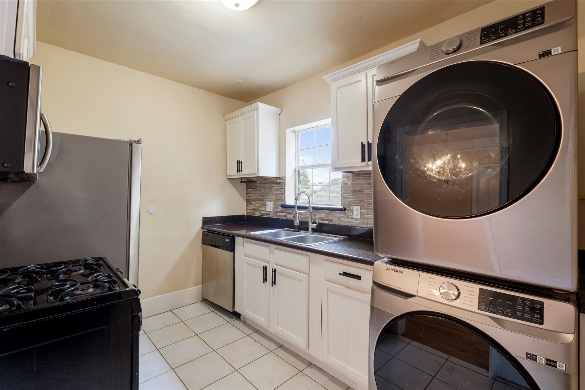 3005 Arbor Street, Unit B Houston, TX 77004 - Photo 12 of 22 a kitchen with a sink and a stove top oven