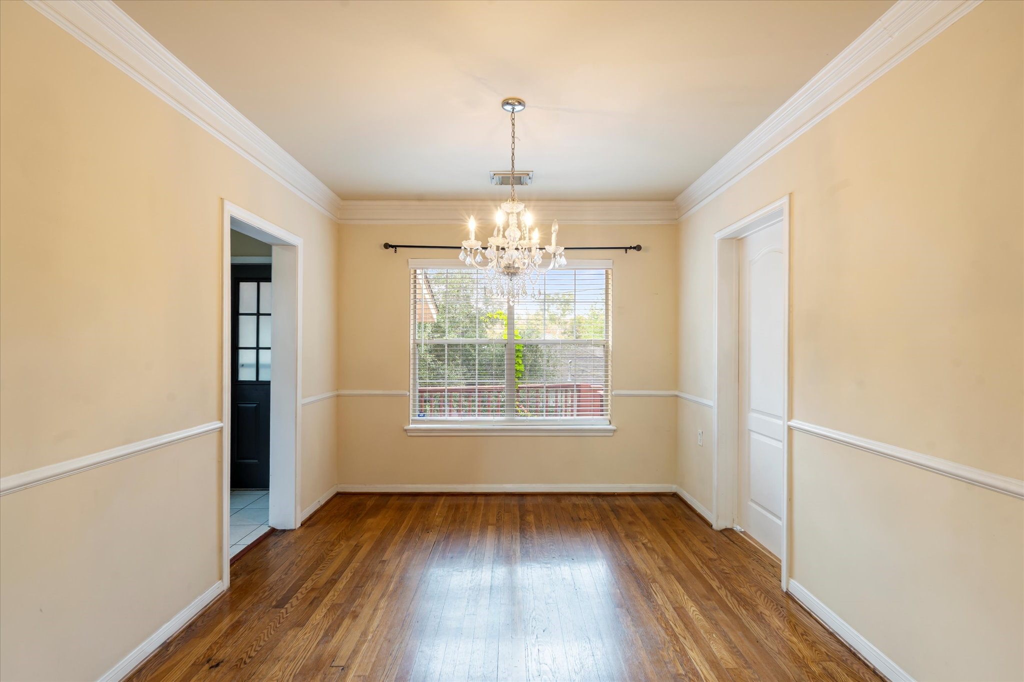 3005 Arbor Street, Unit B Houston, TX 77004 - Photo 6 of 22 a view of an empty room with wooden floor and a window