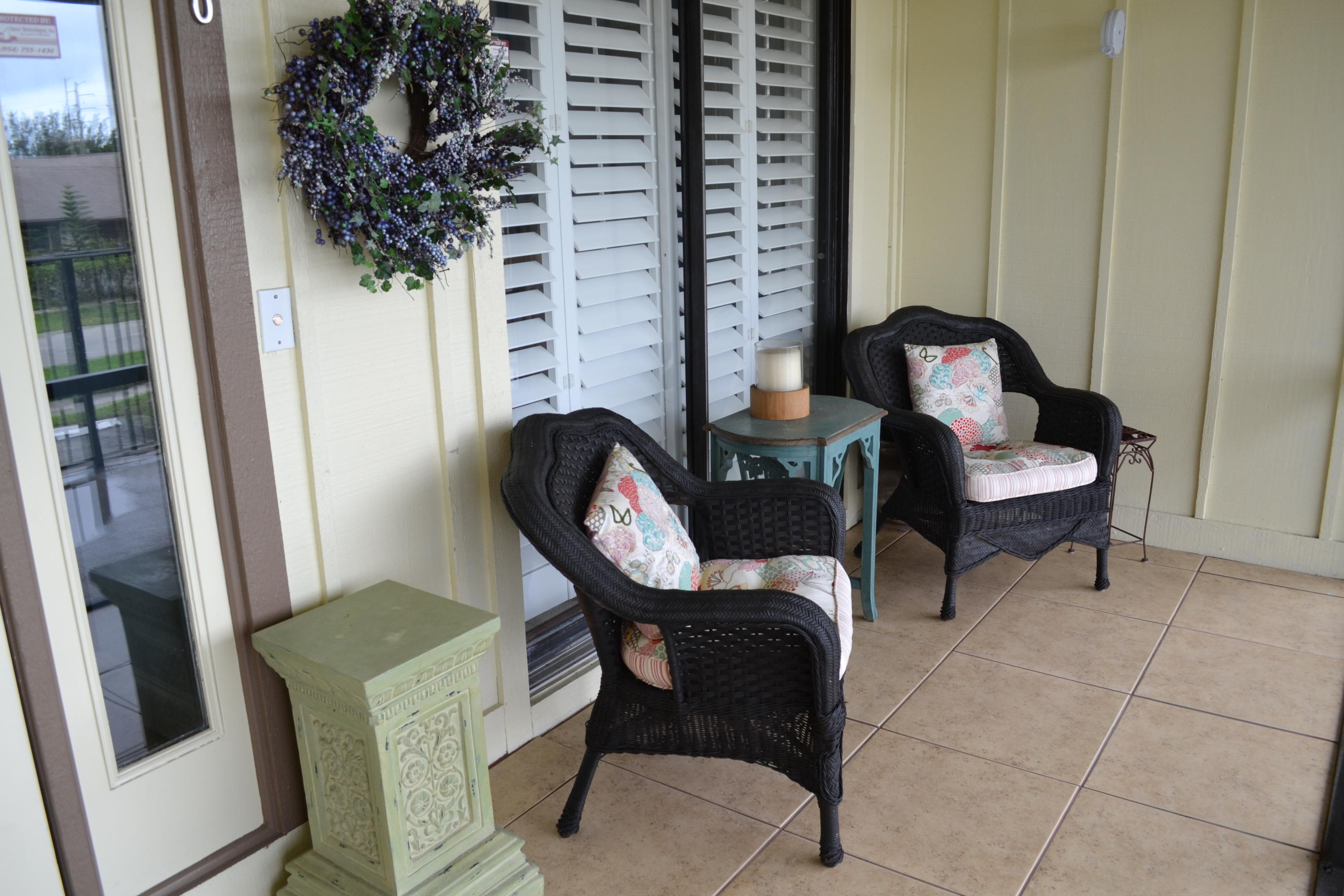 201 Southwest 1st Street, Unit 8 Boca Raton, FL 33432 - Photo 2 of 27 a view of a room with chairs and a potted plant