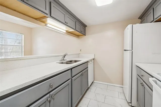 an empty room with a window and a ceiling fan